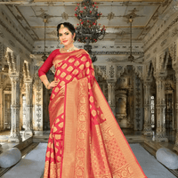 Model draped in wine red Banarasi silk saree with gold motifs, posing in royal interior