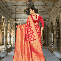 Graceful pallu of red-gold Banarasi silk saree flowing over shoulder in palace backdrop