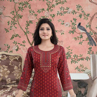 Front view of red kurti bathed in fading sunset