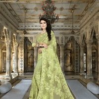 Model in poised step, pista green fabric flowing like painted spring air