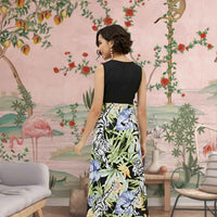 Back angle of the dress capturing the full floral explosion from midnight black to multicolor blooms