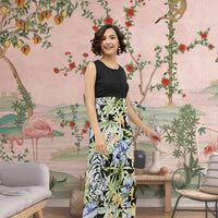 Front view of the Eventide Sonnet dress showing black bodice melting into dawn-colored florals, modeled against a fading sunset