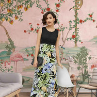 Front view of the Eventide Sonnet dress showing black bodice melting into dawn-colored florals, modeled against a fading sunset
