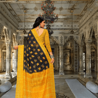 Model flipping pallu to show abstract yellow-black patterns