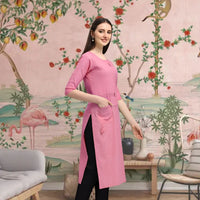 Side angle of straight pink kurti styled in traditional backdrop