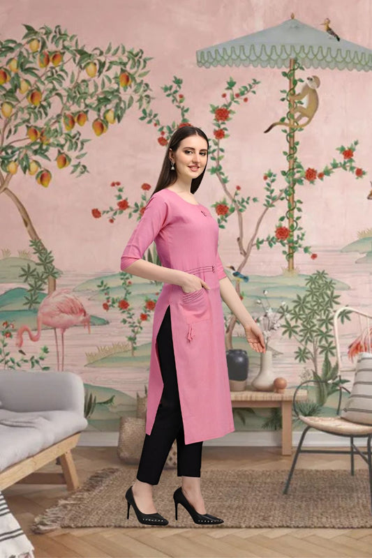 Side angle of straight pink kurti styled in traditional backdrop