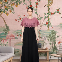  Front view of peach and black sleeveless gown in royal background