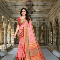 Model in soft pink saree offering side pose in a regal interior setting with poised elegance