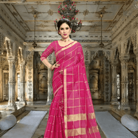 Model walking past heritage columns, saree flowing like prayer in motion, checkered pink gleaming under sunrays