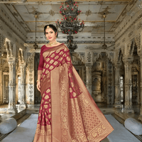 Model in maroon Banarasi silk saree with golden motifs standing in palace room