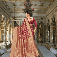 Extended pallu of maroon saree with intricate gold work displayed in regal interior