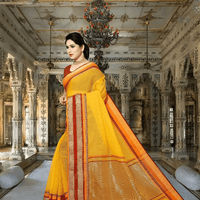Graceful shot, yellow saree radiating calm against earthy backdrop