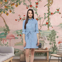  Front view of blue denim dress with rolled sleeves against wooden pier