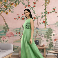 Right view of full-length sleeveless gown in green color