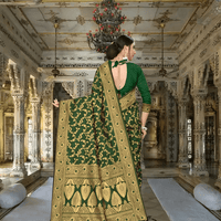 Golden zari pallu cascading on deep green silk in palace backdrop