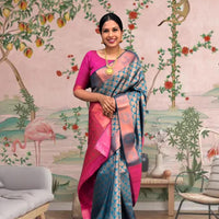 Front view of blue-green printed Litchi silk saree with pink blouse in palace setting