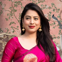 Front view of pink silk printed saree in royal setting