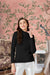 Front view of black high-neck t-shirt with full sleeves in palace backdrop
