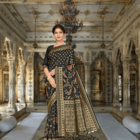 Model in black Banarasi silk saree with golden patterns standing in palace room
