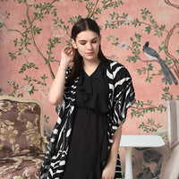 Front view of black printed women’s shrug by CELESTINA