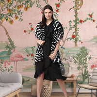 Front view of black printed women’s shrug by CELESTINA