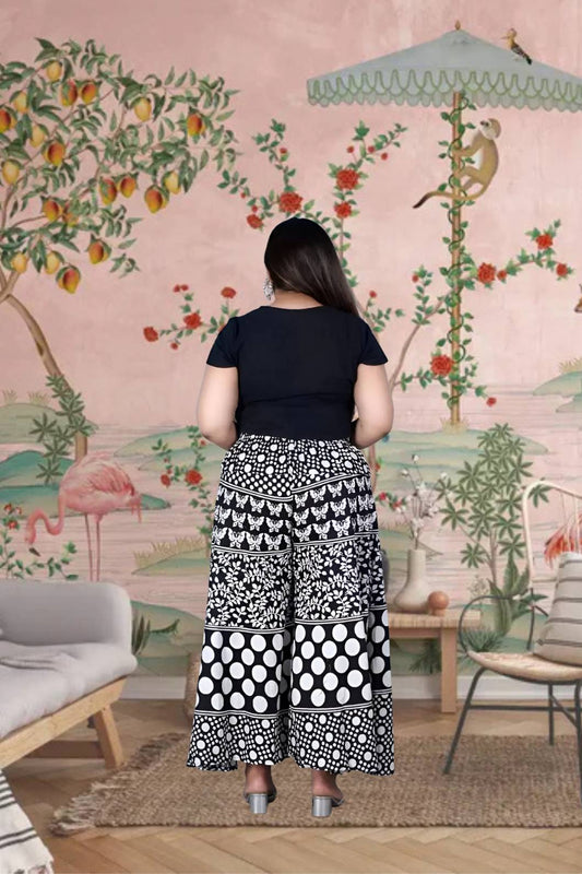  Rear silhouette of palazzo revealing gathered drape in motion