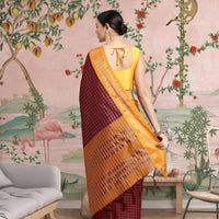 Back view showing pallu fall with yellow-golden borders