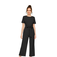 Studio front shot of black cap sleeve jumpsuit – white background