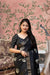 Front angle of black printed saree glowing in palace setting