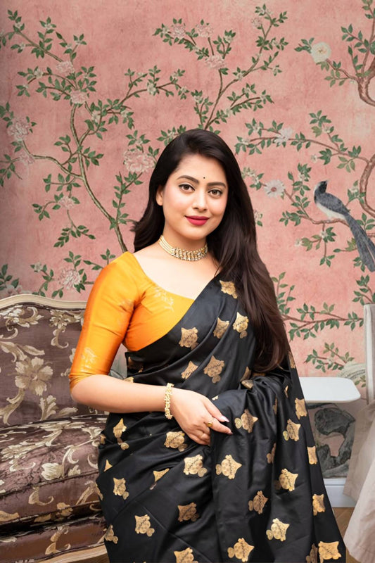  Front view of black silk saree with vibrant yellow blouse in royal palace room