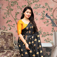  Front view of black silk saree with vibrant yellow blouse in royal palace room