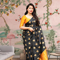  Front view of black silk saree with vibrant yellow blouse in royal palace room
