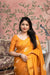 Front angle of yellow cotton crape saree glowing in palace morning light