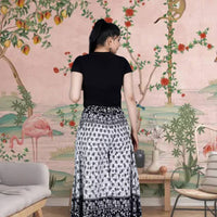 Rear profile of flared pants catching market breeze
