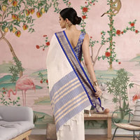 Rear view showcasing deep blue pallu with golden border.