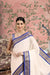 Front view of royal blue checkered saree in regal setting