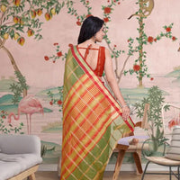 Rear view showcasing soft pallu fall and heritage checks