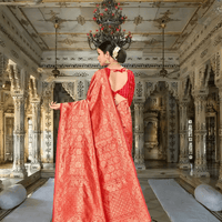 Red Banarasi saree with gold zari pallu displayed inside regal interior
