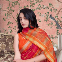 Front view of red checkered saree glowing in palace light
