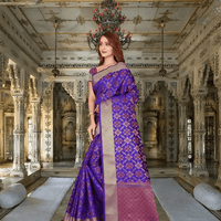 Model draped in purple Kanchivaram silk saree with golden borders in regal setting
