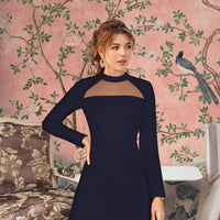 Model in navy blue full-sleeve dress – poised front stance in regal setting