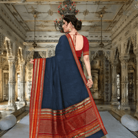 Backshot with bold pallu swing, evoking the silhouette of a classical dancer