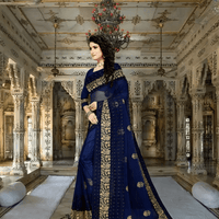Model in navy net saree under royal chandelier glow, borders gleaming with threadwork