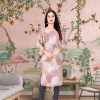 Front view of brown kurti with earthy print against textured mud wall