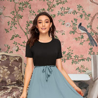 Front view of Monochrome Reverie knit dress in black top and grey skirt