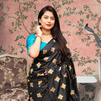 Front view of black silk saree with sky blue blouse in royal setting