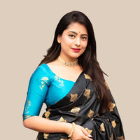 Studio front view of black silk printed saree and blouse contrast