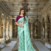 Model in light pista green cotton saree with floral prints, standing in regal palace room