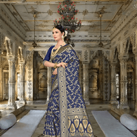 Golden pallu on navy saree cascading elegantly in a regal setting