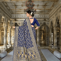 Close-up of gold motifs on navy silk blend fabric with royal décor